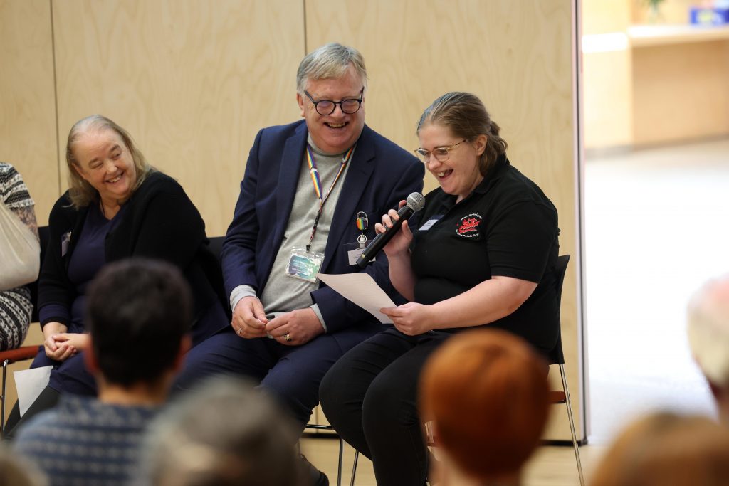 Photograph of members of the Lived Experience Collective speaking on a panel at the launch event for the Centre for Adult Social Care Research (CARE).